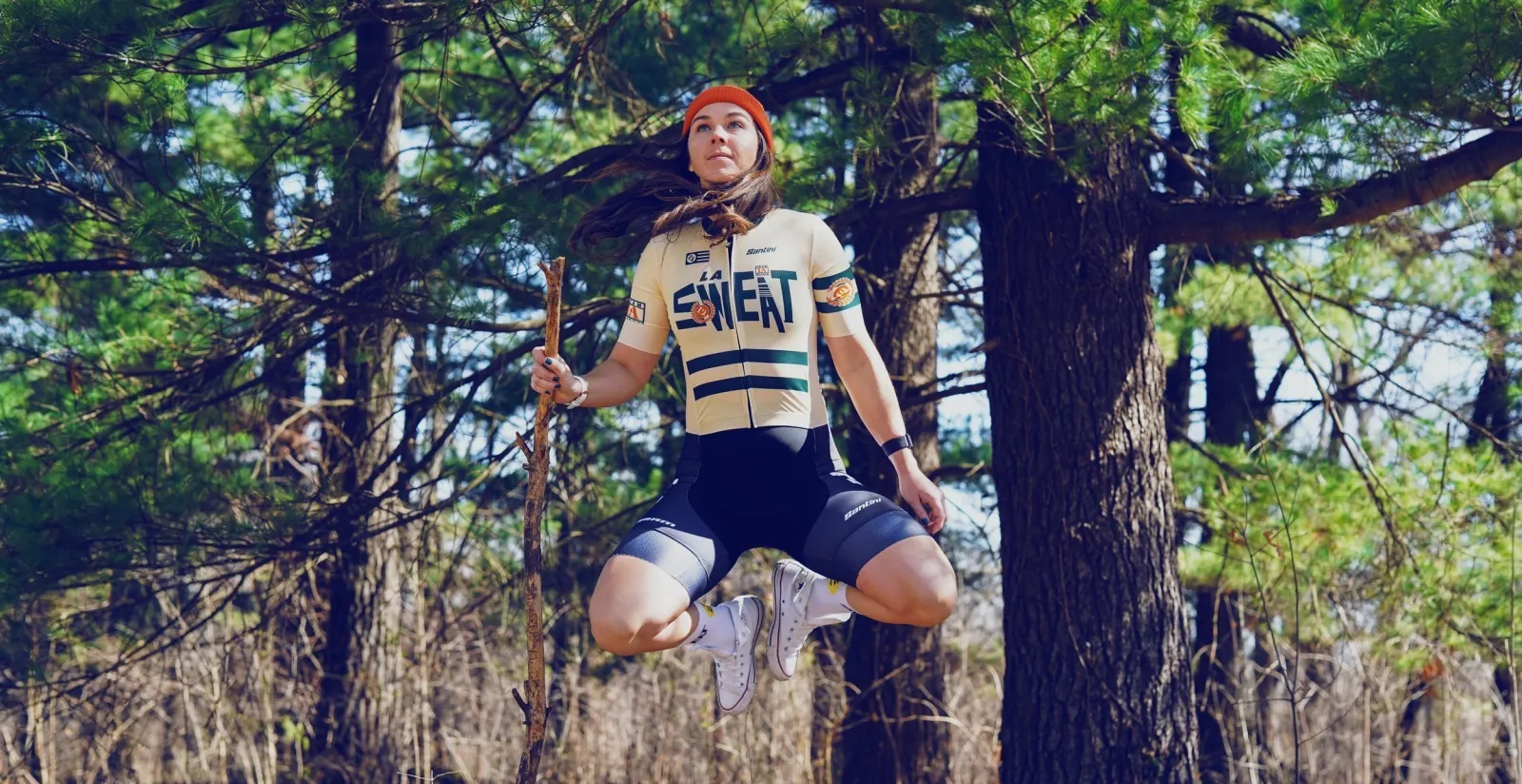 Ashley mid-jump in the woods for LA Sweat